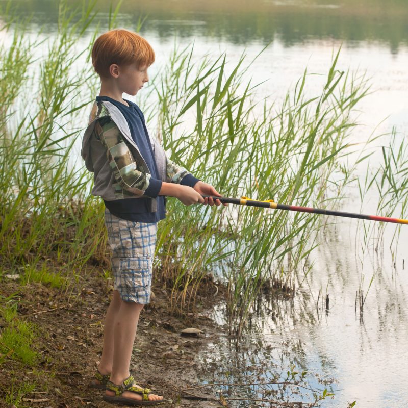 young boy fishing in a lake