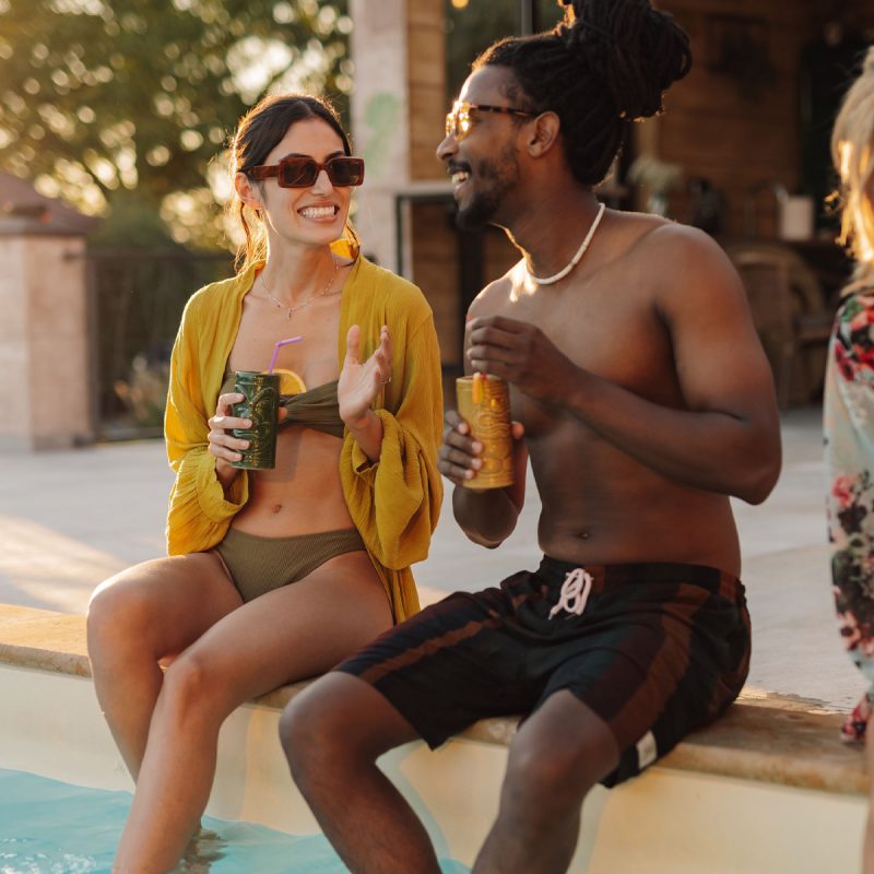 friends enjoying drinks by the poolside